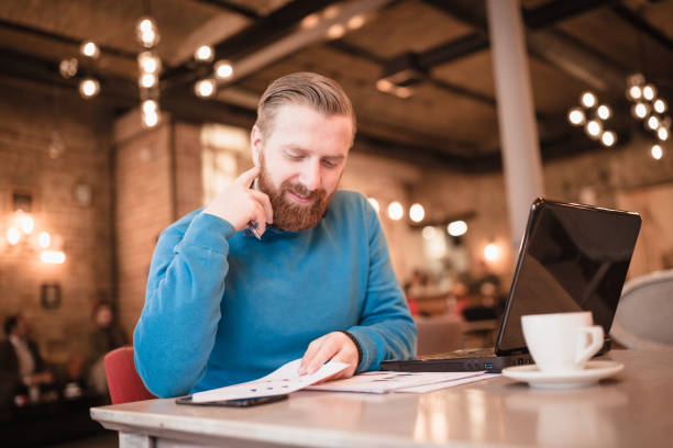 istock Young, redhead businessman, on coffee break, using laptop 1049697662