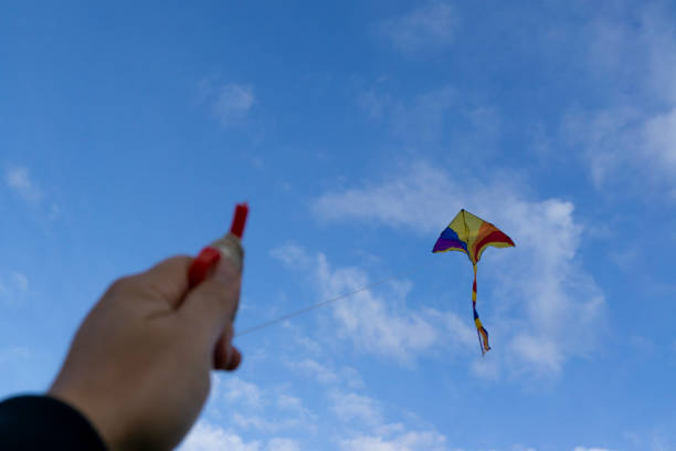 istock kite flying in a beautiful sky clouds. 1049697906