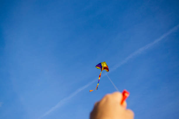 istock kite flying in a beautiful sky clouds. 1049700806