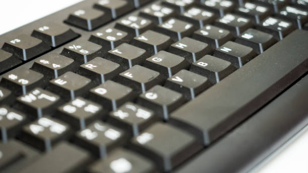 istock Close up of black keyboard of a modern computer on white background 1049701188