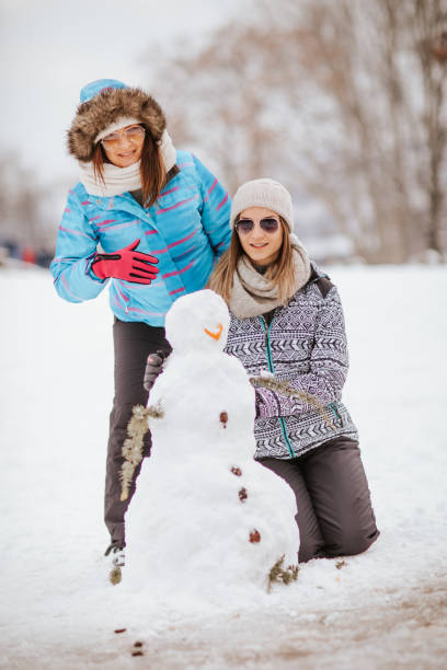 istock Two friends make the snowman 1049701204