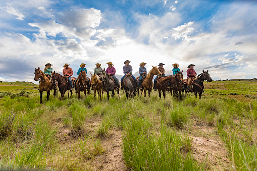 Backlit Line Up of a Group of Cowboys and Cowgirls