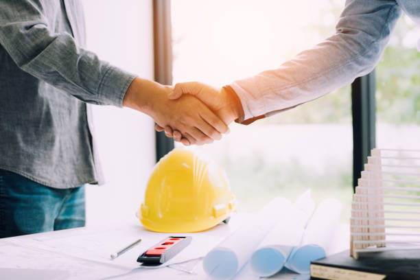 istock Construction worker greeting a foreman at renovating apartment. 1049701658