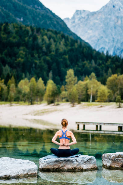 istock Young woman meditating in nature 1049704934