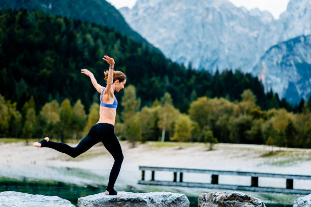 istock Young yogi woman jumping on rocks 1049704940