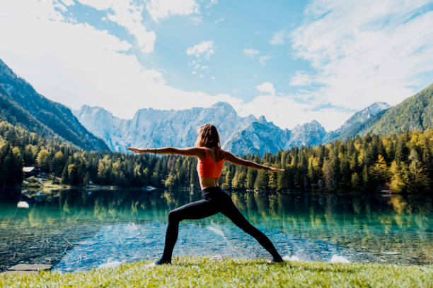 istock Woman practising the warrior pose in nature 1049704988
