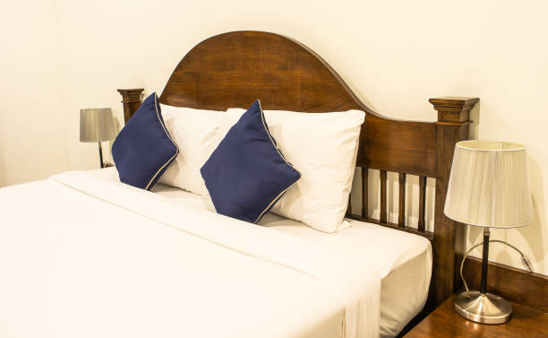 istock Double bed in hotel room, In the equipment light background 1049707636
