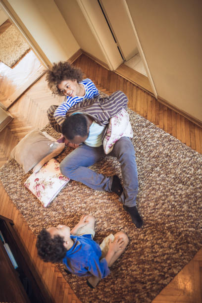istock Kids having fun at home, playing with their father at home. 1049711424