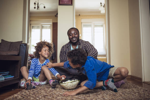 istock Kids having fun at home, playing with their father at home. 1049711440