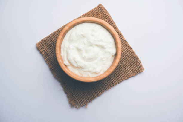 istock Plain curd or yogurt or Dahi in Hindi, served in a bowl over moody background. Selective focus 1049714318
