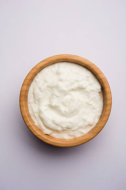 istock Plain curd or yogurt or Dahi in Hindi, served in a bowl over moody background. Selective focus 1049714374