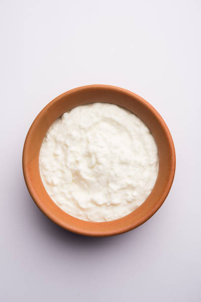 istock Plain curd or yogurt or Dahi in Hindi, served in a bowl over moody background. Selective focus 1049714506