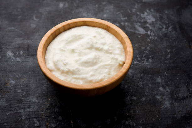 istock Plain curd or yogurt or Dahi in Hindi, served in a bowl over moody background. Selective focus 1049714630