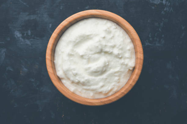 istock Plain curd or yogurt or Dahi in Hindi, served in a bowl over moody background. Selective focus 1049714650