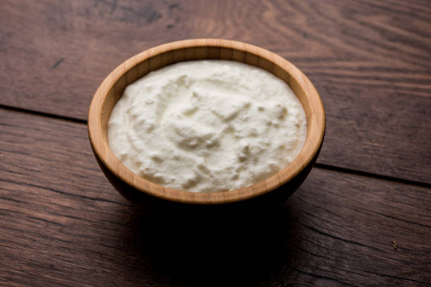 istock Plain curd or yogurt or Dahi in Hindi, served in a bowl over moody background. Selective focus 1049714774