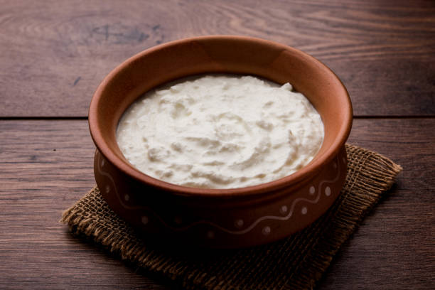 istock Plain curd or yogurt or Dahi in Hindi, served in a bowl over moody background. Selective focus 1049714870