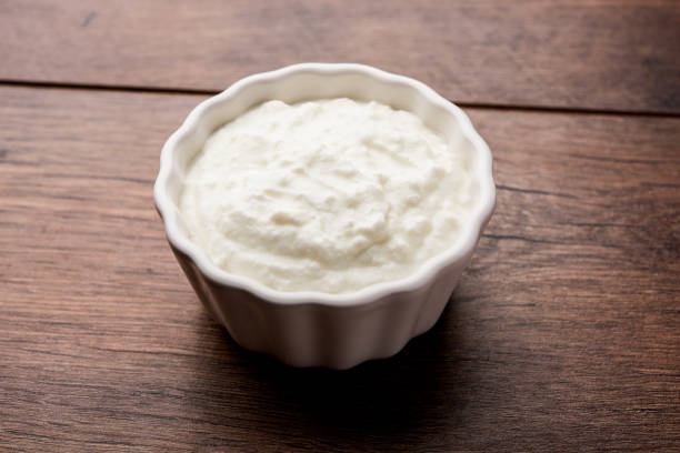 istock Plain curd or yogurt or Dahi in Hindi, served in a bowl over moody background. Selective focus 1049715016