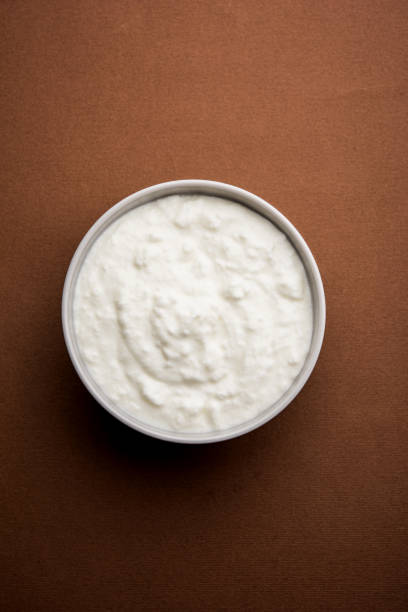 istock Plain curd or yogurt or Dahi in Hindi, served in a bowl over moody background. Selective focus 1049715162
