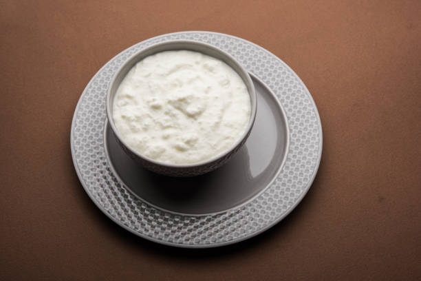 istock Plain curd or yogurt or Dahi in Hindi, served in a bowl over moody background. Selective focus 1049715200