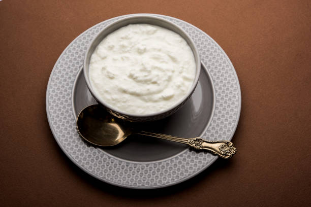 istock Plain curd or yogurt or Dahi in Hindi, served in a bowl over moody background. Selective focus 1049717158