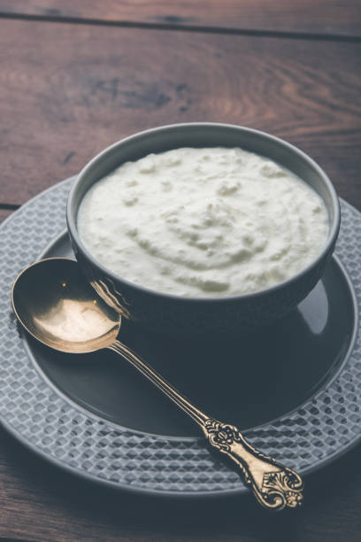 istock Plain curd or yogurt or Dahi in Hindi, served in a bowl over moody background. Selective focus 1049717354