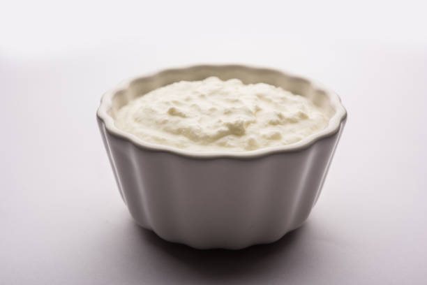 istock Plain curd or yogurt or Dahi in Hindi, served in a bowl over moody background. Selective focus 1049717532