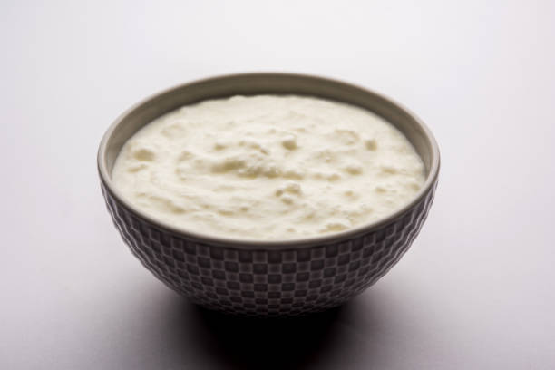 istock Plain curd or yogurt or Dahi in Hindi, served in a bowl over moody background. Selective focus 1049717638