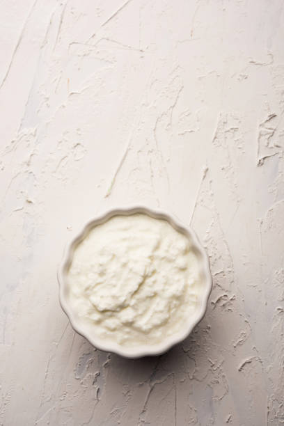 istock Plain curd or yogurt or Dahi in Hindi, served in a bowl over moody background. Selective focus 1049717808