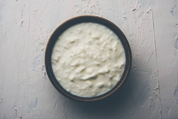 istock Plain curd or yogurt or Dahi in Hindi, served in a bowl over moody background. Selective focus 1049717822