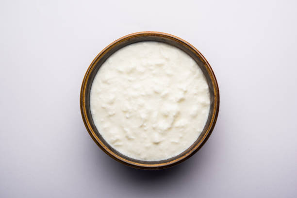 istock Plain curd or yogurt or Dahi in Hindi, served in a bowl over moody background. Selective focus 1049717918