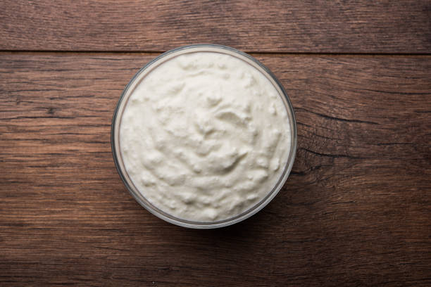 istock Plain curd or yogurt or Dahi in Hindi, served in a bowl over moody background. Selective focus 1049718062