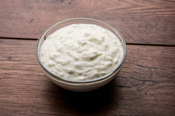 istock Plain curd or yogurt or Dahi in Hindi, served in a bowl over moody background. Selective focus 1049718098