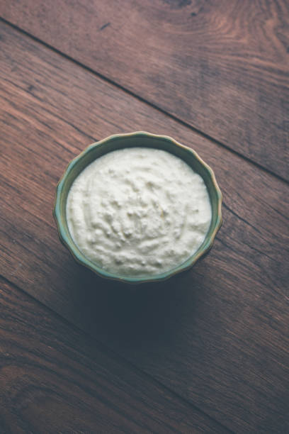 istock Plain curd or yogurt or Dahi in Hindi, served in a bowl over moody background. Selective focus 1049718238