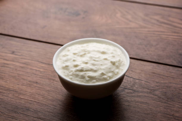 istock Plain curd or yogurt or Dahi in Hindi, served in a bowl over moody background. Selective focus 1049718292