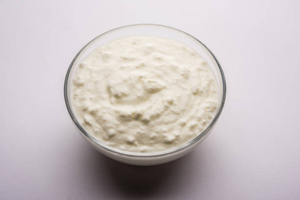 istock Plain curd or yogurt or Dahi in Hindi, served in a bowl over moody background. Selective focus 1049718552