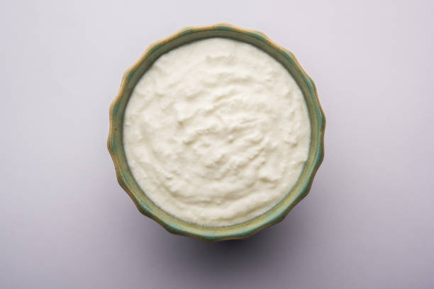istock Plain curd or yogurt or Dahi in Hindi, served in a bowl over moody background. Selective focus 1049718710