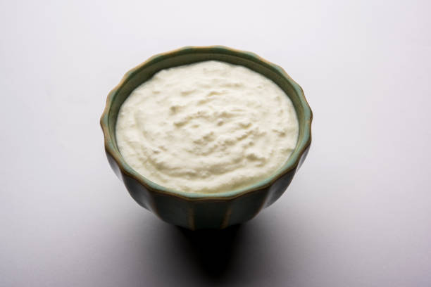 istock Plain curd or yogurt or Dahi in Hindi, served in a bowl over moody background. Selective focus 1049718760