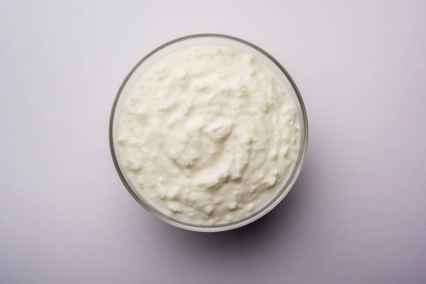 istock Plain curd or yogurt or Dahi in Hindi, served in a bowl over moody background. Selective focus 1049718830