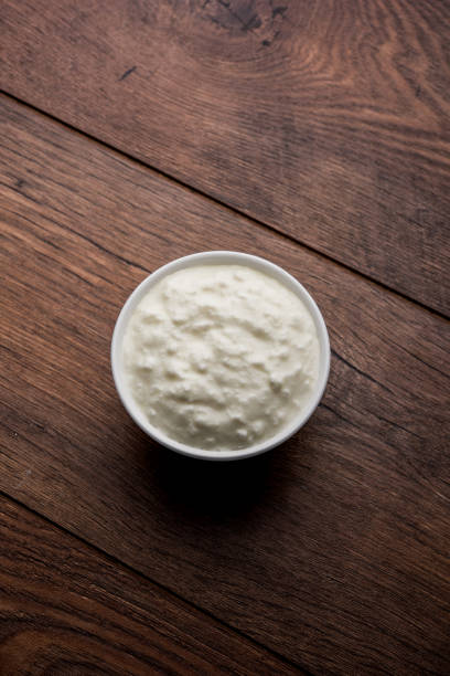 istock Plain curd or yogurt or Dahi in Hindi, served in a bowl over moody background. Selective focus 1049719042