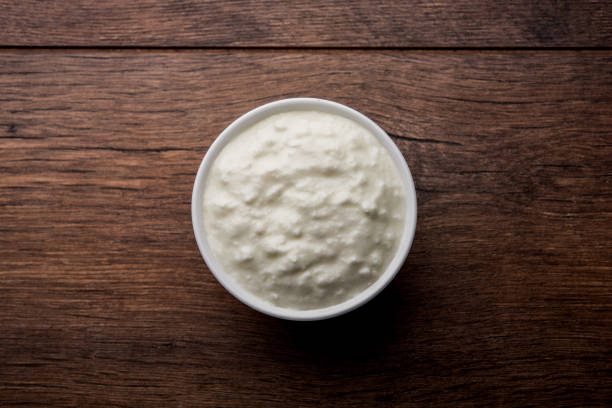 istock Plain curd or yogurt or Dahi in Hindi, served in a bowl over moody background. Selective focus 1049719098