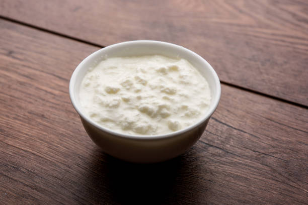 istock Plain curd or yogurt or Dahi in Hindi, served in a bowl over moody background. Selective focus 1049719172