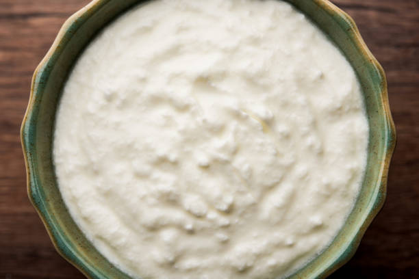 istock Plain curd or yogurt or Dahi in Hindi, served in a bowl over moody background. Selective focus 1049719296