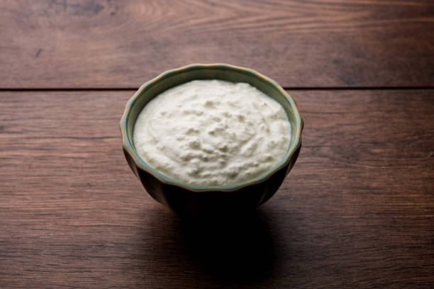 istock Plain curd or yogurt or Dahi in Hindi, served in a bowl over moody background. Selective focus 1049720010