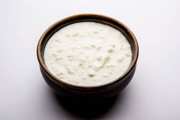 istock Plain curd or yogurt or Dahi in Hindi, served in a bowl over moody background. Selective focus 1049721582