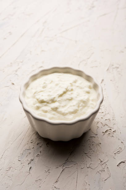 istock Plain curd or yogurt or Dahi in Hindi, served in a bowl over moody background. Selective focus 1049721688