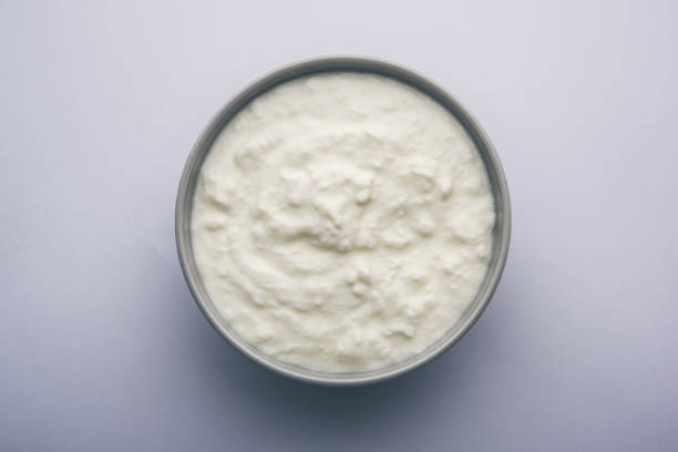 istock Plain curd or yogurt or Dahi in Hindi, served in a bowl over moody background. Selective focus 1049721708
