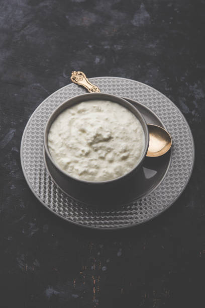 Plain curd or yogurt or Dahi in Hindi, served in a bowl over moody background. Selective focus