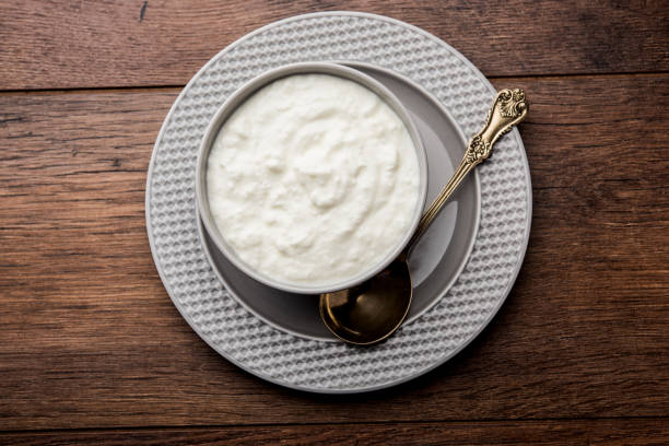 istock Plain curd or yogurt or Dahi in Hindi, served in a bowl over moody background. Selective focus 1049721902