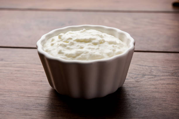 istock Plain curd or yogurt or Dahi in Hindi, served in a bowl over moody background. Selective focus 1049721984