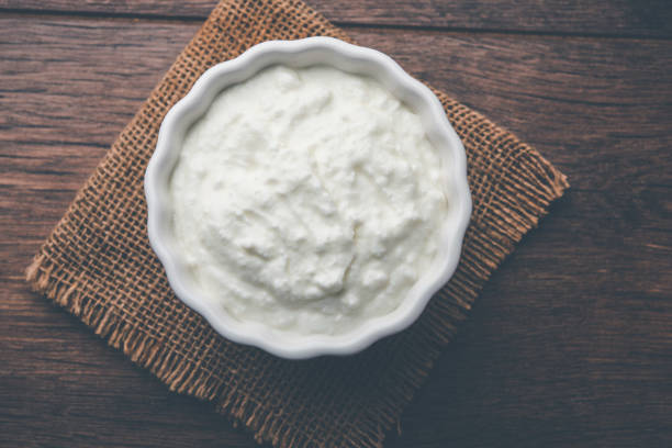 istock Plain curd or yogurt or Dahi in Hindi, served in a bowl over moody background. Selective focus 1049722086
